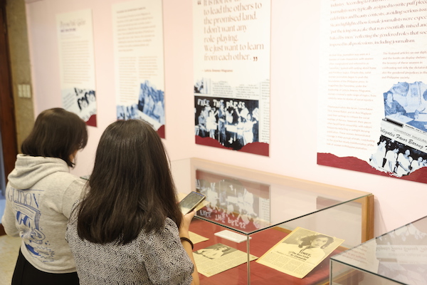 Students view the exhibit of Beyond the Gloss and Discipline