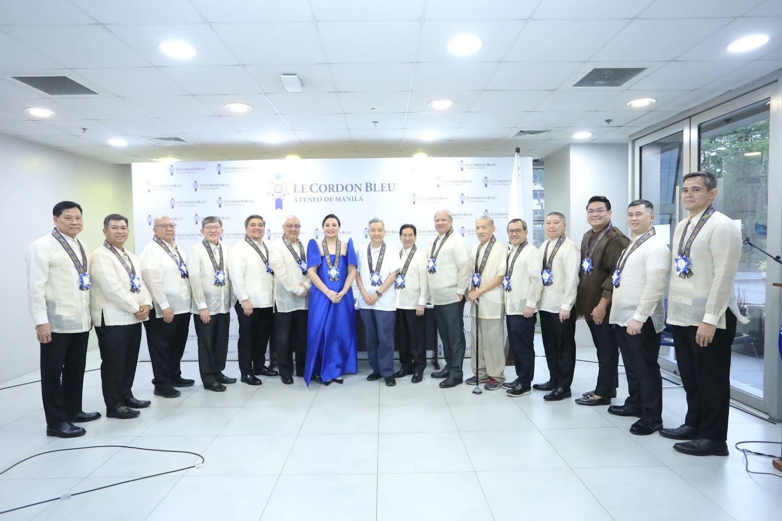 Ateneo de Manila University President Fr. Roberto C. Yap, SJ and Office of University Development and Alumni Affairs (OUDAA) Director Fr. Norberto L. Bautista, SJ poses with the newly inducted 2025-2026 Ateneo Alumni Association (AAA) President Atty. Steff Baltao - Basilio (center) and Board of Trustees.