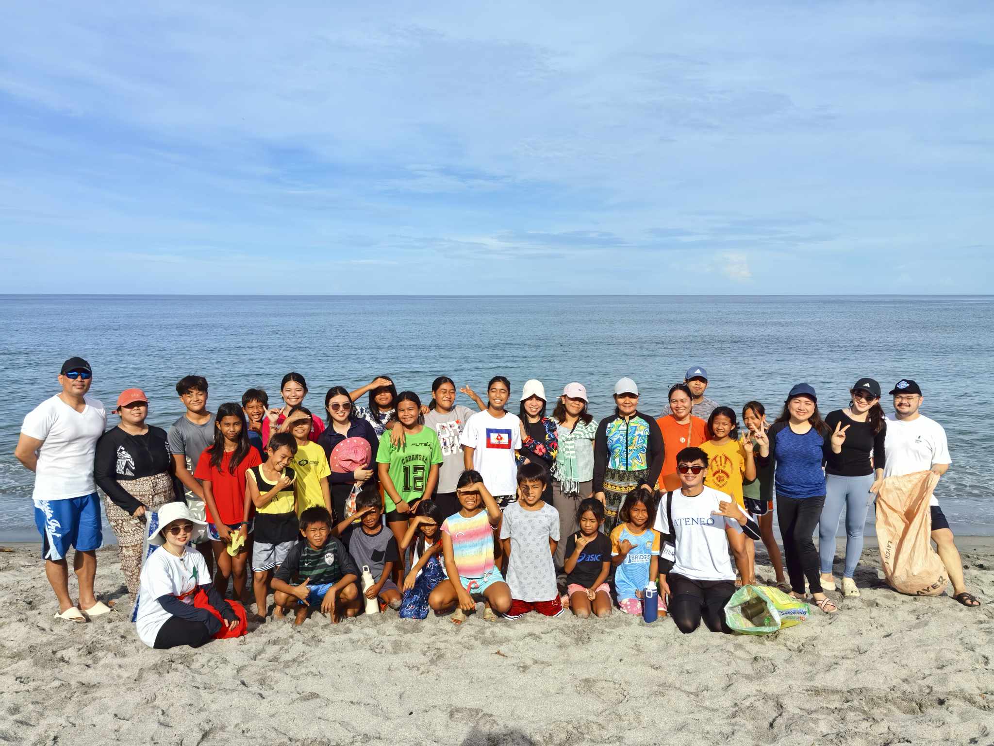 AJHS faculty and staff with Alon at Araw child volunteers after the beach clean-up in Cabangan, Zambales