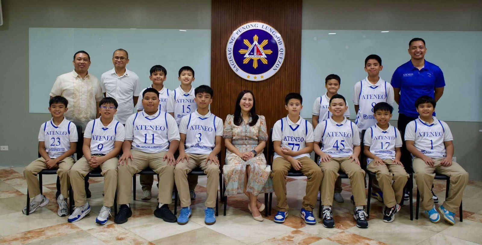 Front row from left: Matteo Lanot, Rossher Samson, Prince Torio, Julian Baliwag, Quezon City mayor Joy Belmonte, Ryley Floirendo, Jeric Espiritu, Julian German, Theo Del Mundo; back row from left: Atty Rene Grapilon (Assistant City Administrator for General Affairs), Mr. Benjamin Afuang (QC Sports Action Officer), Noah Sardea, Joaquin Luz, Eli Martires, RyRy De Guzman, Coach Monroe Cueson