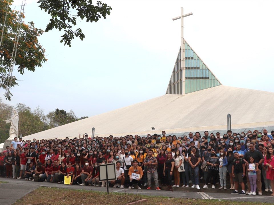Pathways community pose along the steps of the Church of the Gesu in the foreground. In the background, the church's cross is seen.