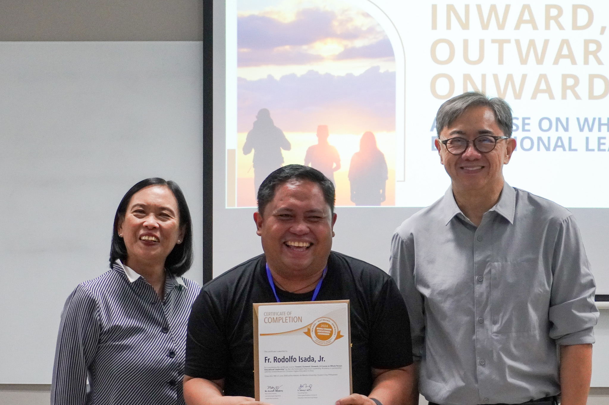 Fr Rodolfo Isada Jr of Diocesan Clergy of Malaybalay Diocese, Bukidnon receiving his certificate of completion from the facilitators, Fr Johnny and Dr Cuyegkeng