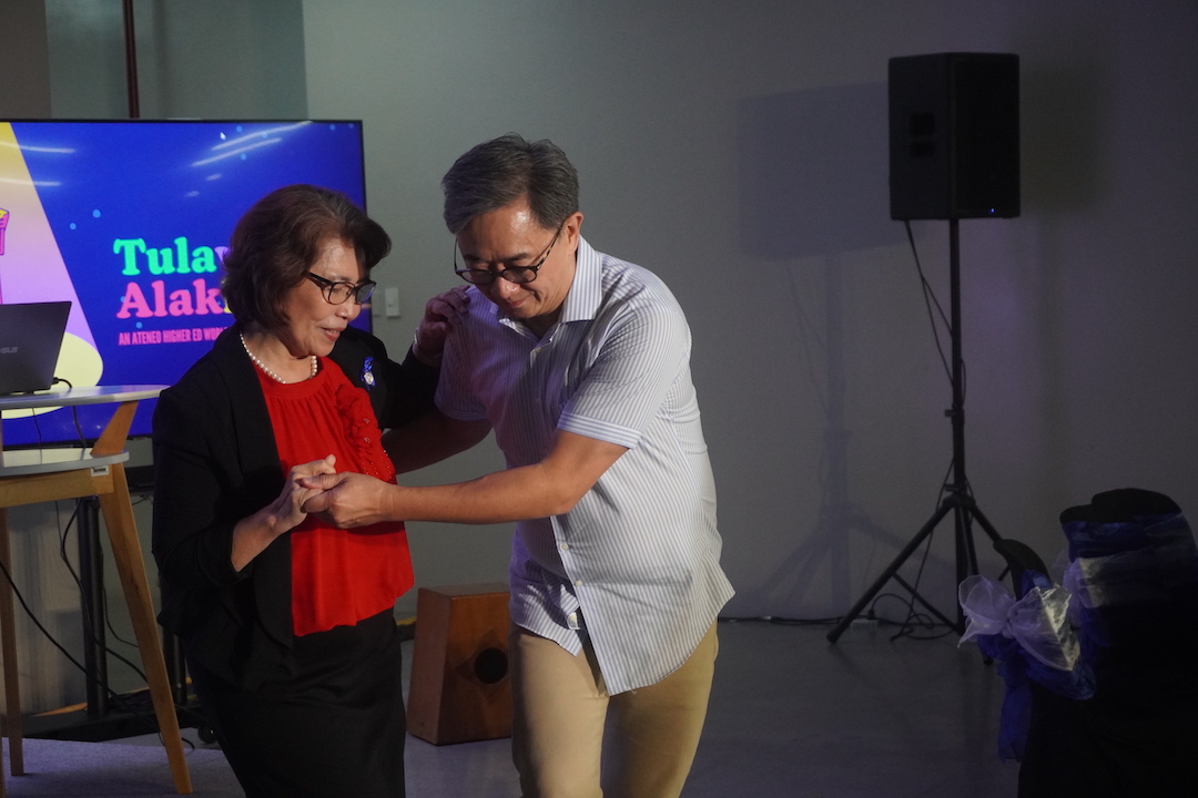 Doc Marlu boogies with one of her deans, Fr. Johnny. Dean Paeng, Robby, and Jonathan, next!