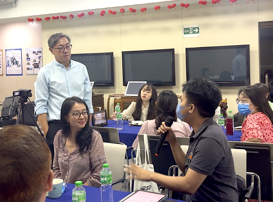 Fr Johnny Go conversing with participant