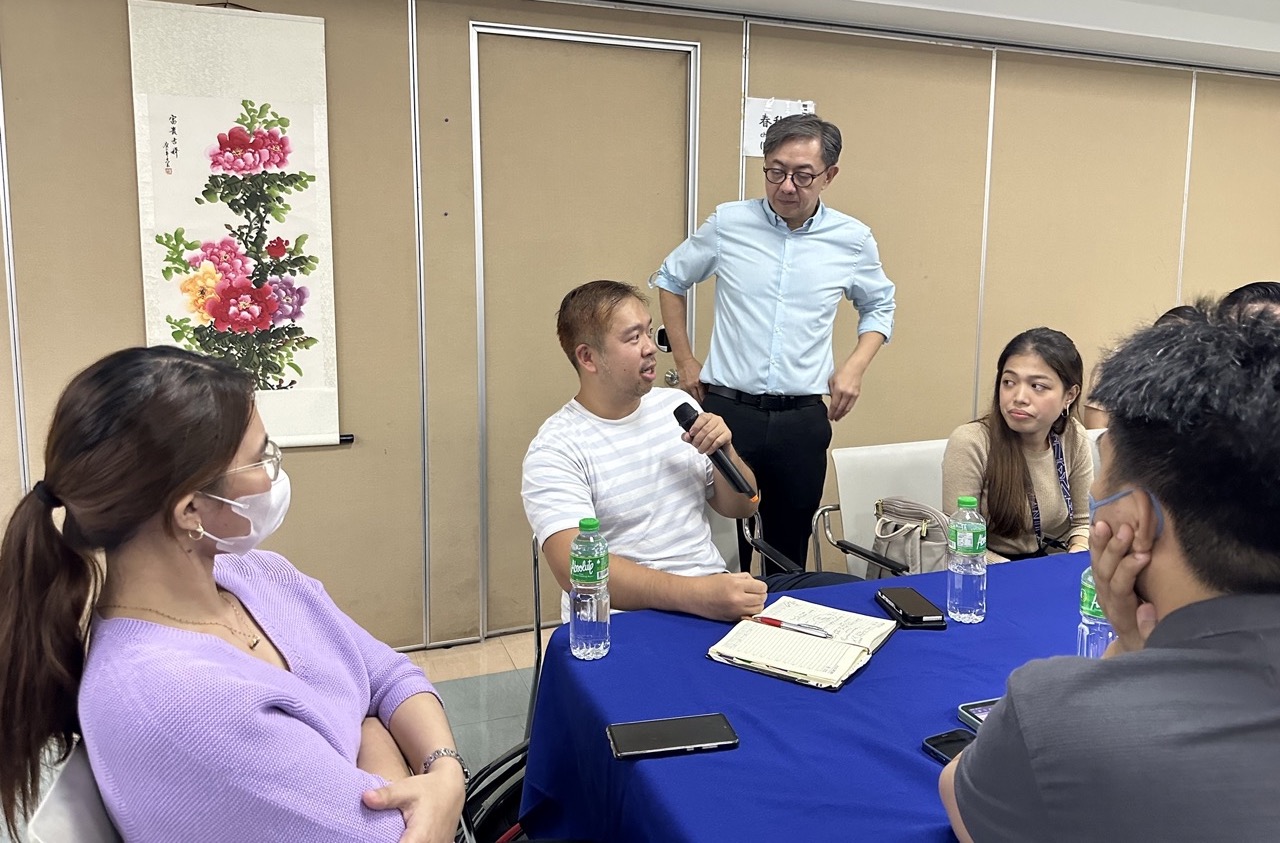 Fr Johnny Go conversing with participant 2