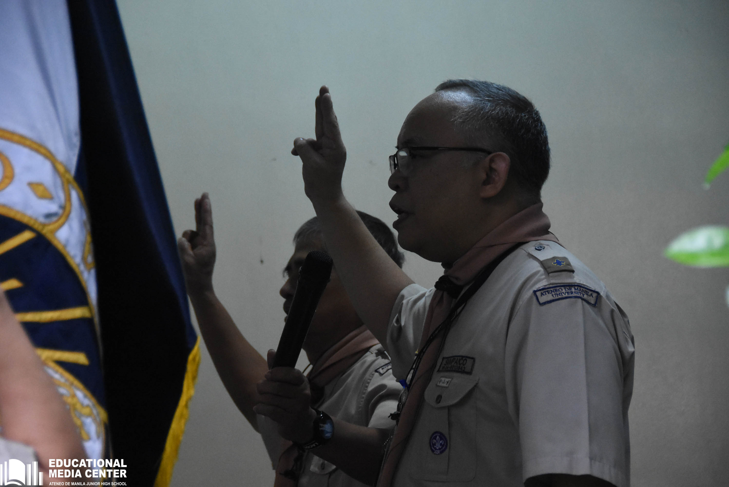 Fr Jonjee Sumpaico SJ and Ariel Tamayo lead the Scouts in reciting the Scout Oath and Law during the opening ceremony