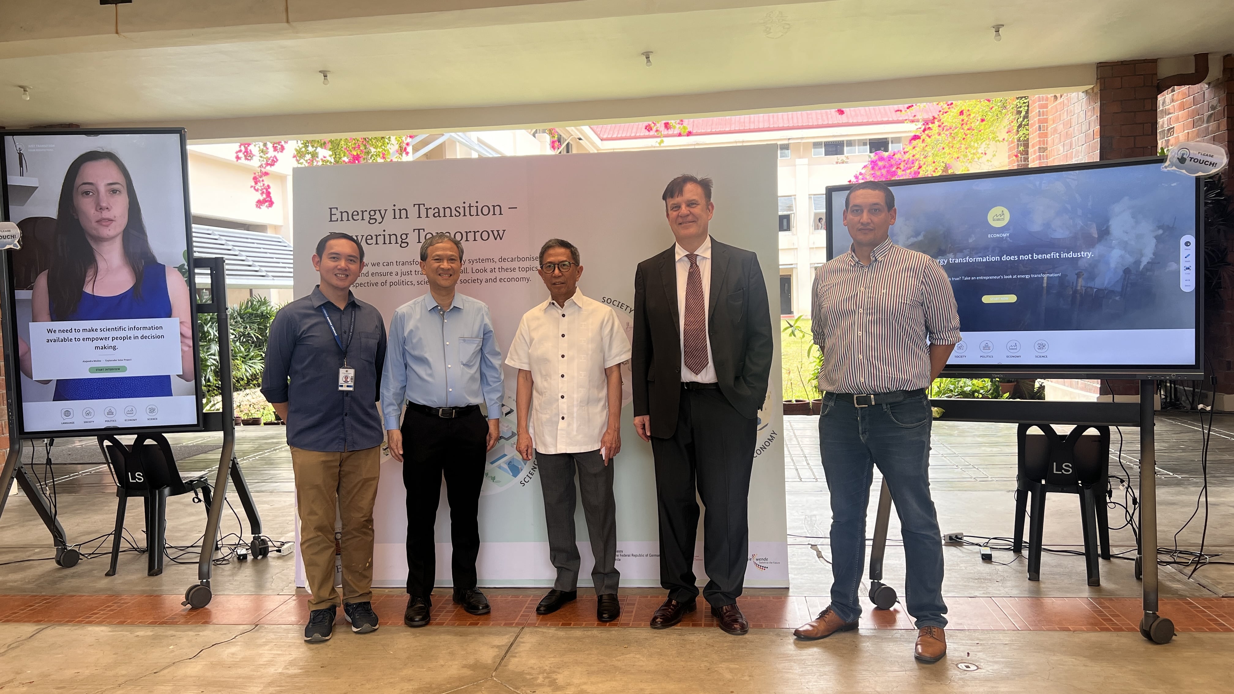 DOE Secretary Lotilla, flanked by officials from AIS and GIZ