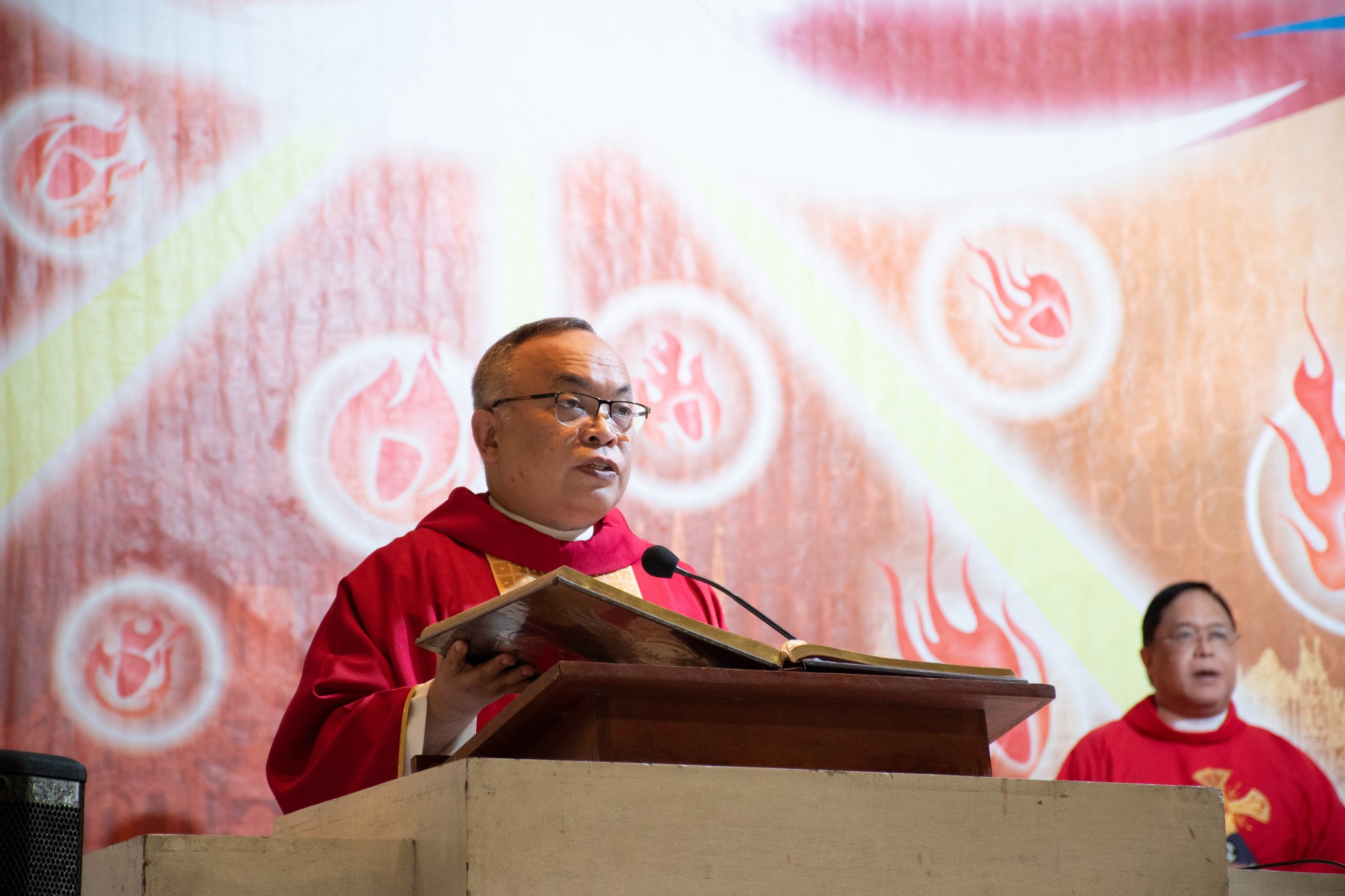 Fr Jonjee Sumpaico SJ proclaims the Gospel