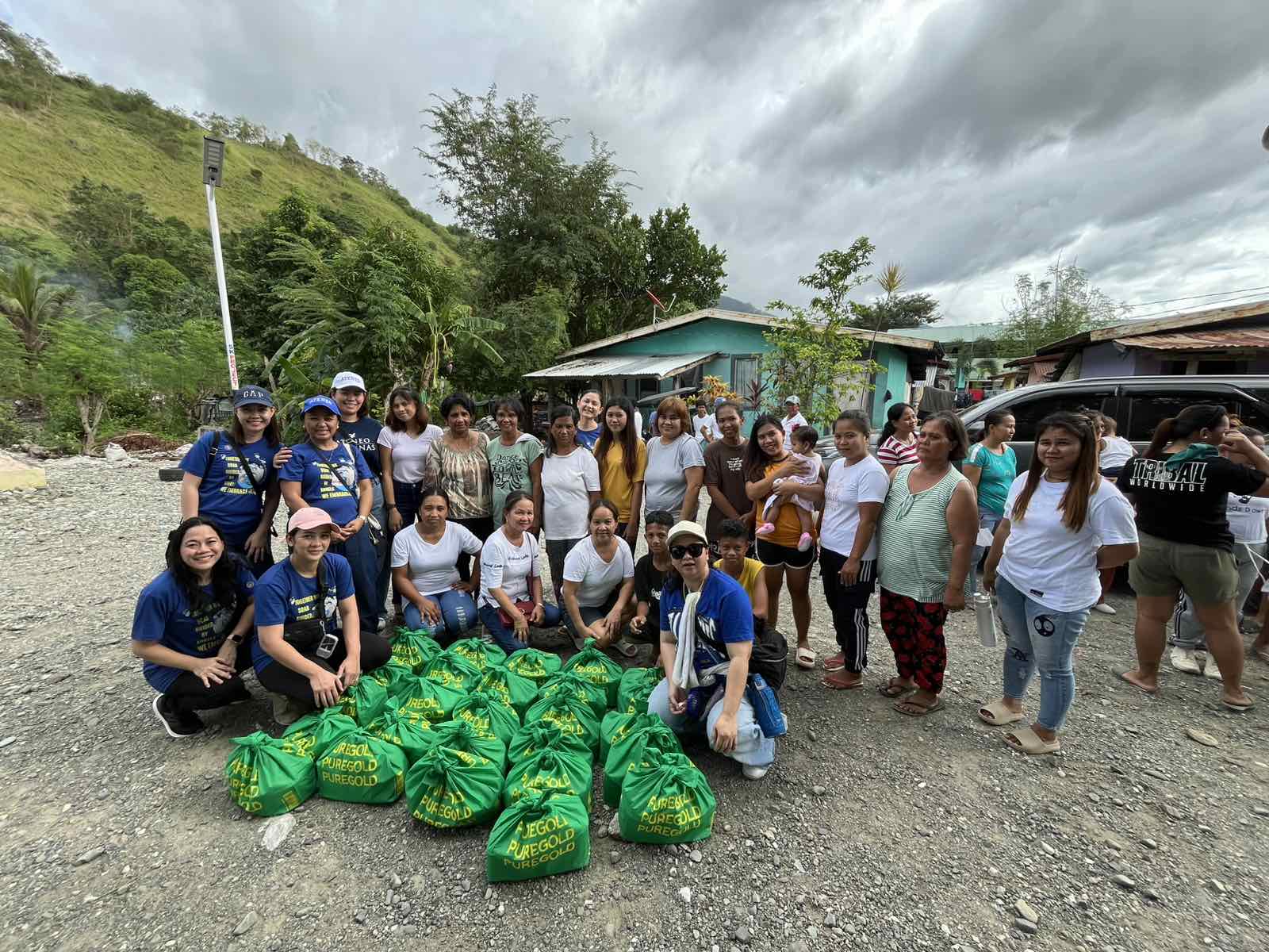 AGS Kindergarten parents giving out Christmas food packs to the GK Kalayaan families