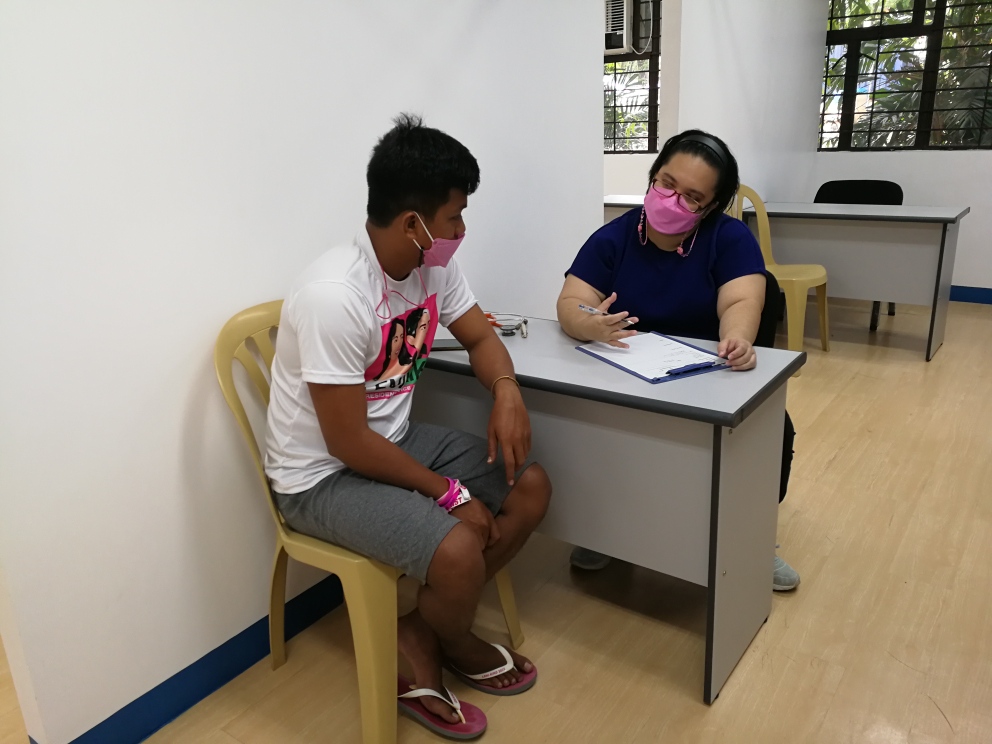 Dr. Izzy Escobillo, Occupational Health Physician under OUPC, interviewing a PAKISAMA/Sumilao farmer