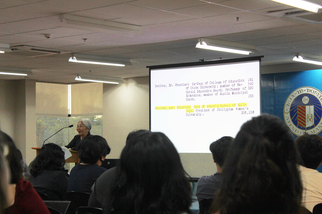 Dr Lucero in front of her slides on Paz Marquez Benitez