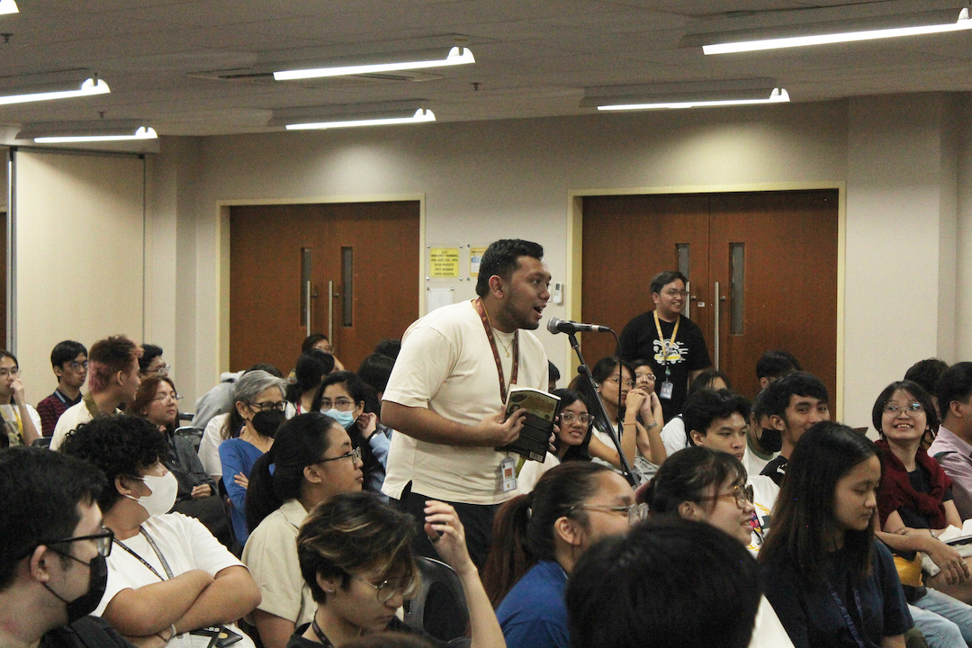 Audience members take the microphone to ask questions