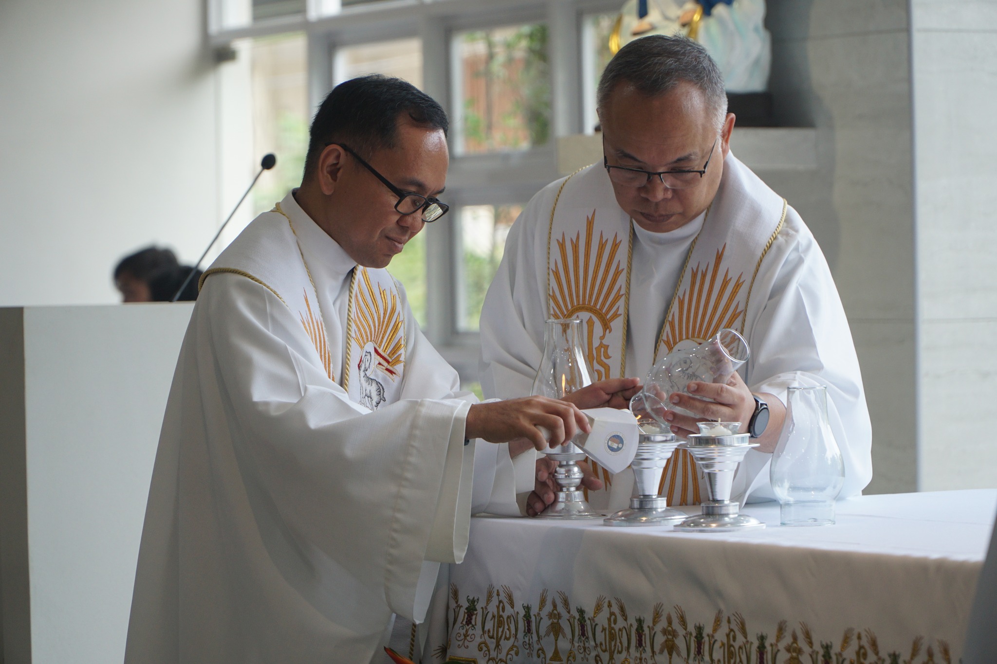 Fr Mamert Mañus SJ (left) and Fr Jonjee Sumpaico SJ (right) during the Lighting of the Altar