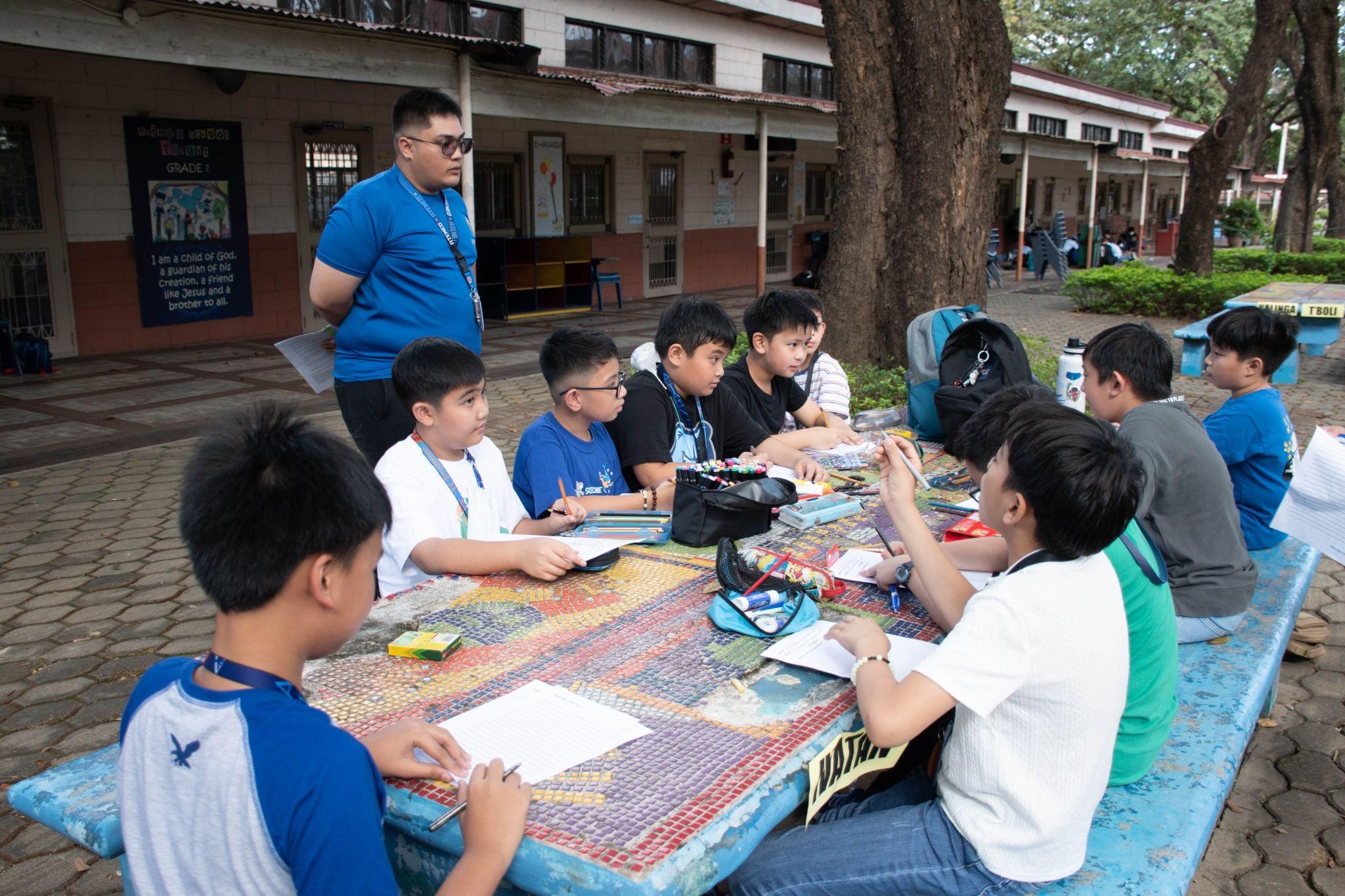 Grade 5 boys discussing the significance of the sacraments