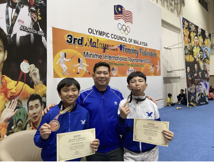 (L-R) Eliam Mojica, Coach Edward Daliva, Aidan Taguinod