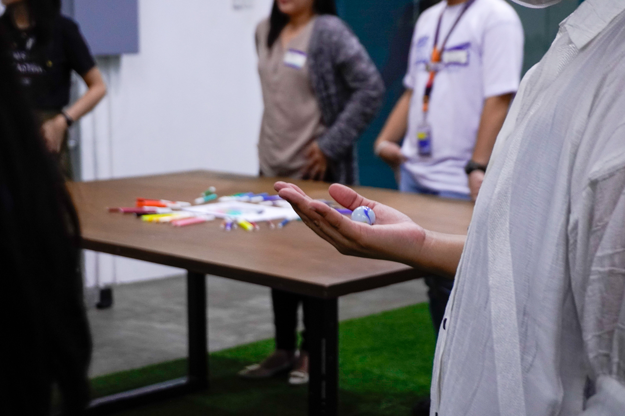 Participant holds a marble as part of the check-in activity