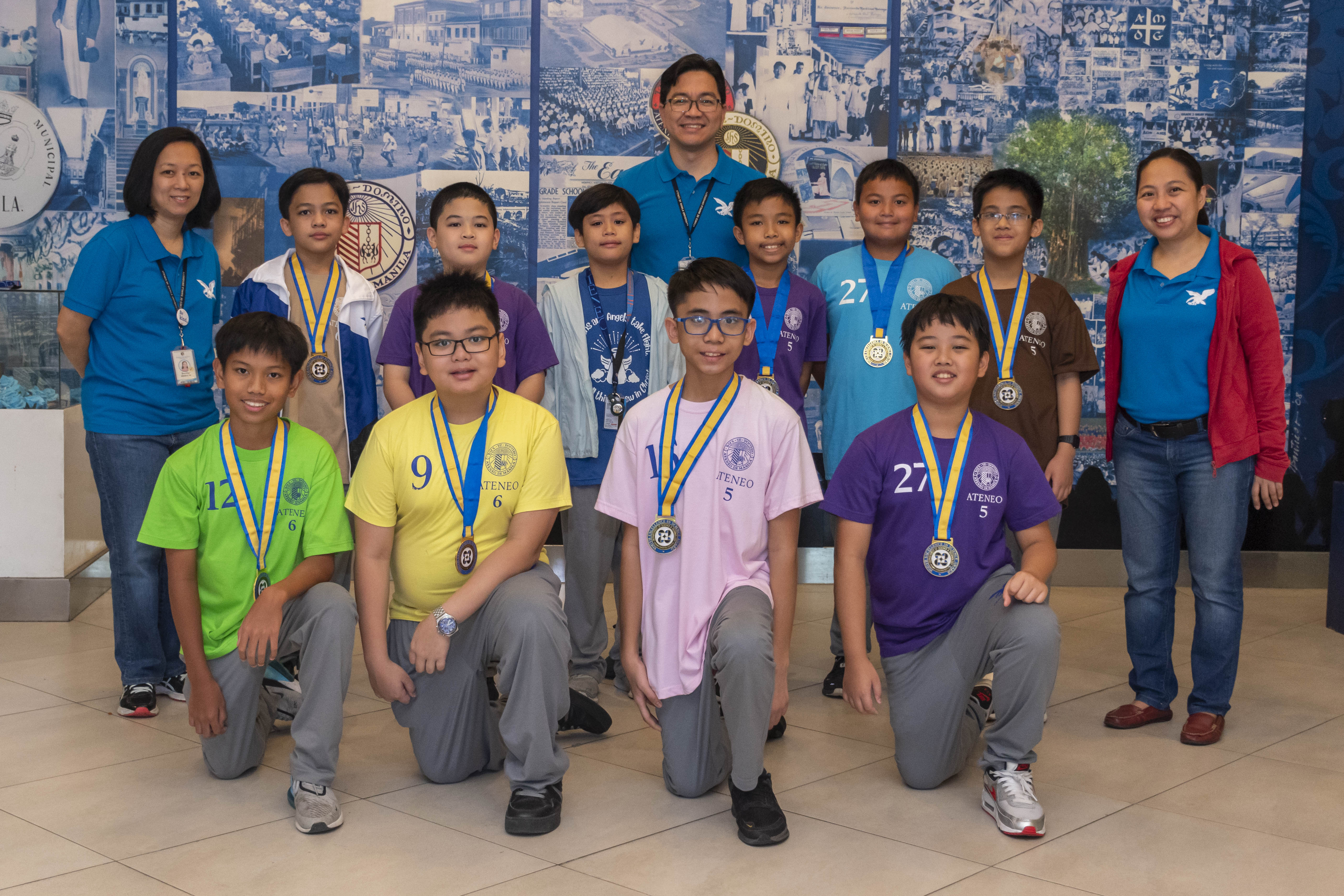 Front row from left: Josh Gonzalez, Koko Dela Cruz, Thad Manuel, Shun Sato; second row from left: Grace Yn (Math Coordinator), Daniel Canaria, Lego Pauig, Magnus Arrojado, Julian German, Miguel Tagarda, Anton Doria, Louise Tulayba (Science Coordinator); behind them: Jervy Robles (Headmaster); not in photo: Mika Bagain