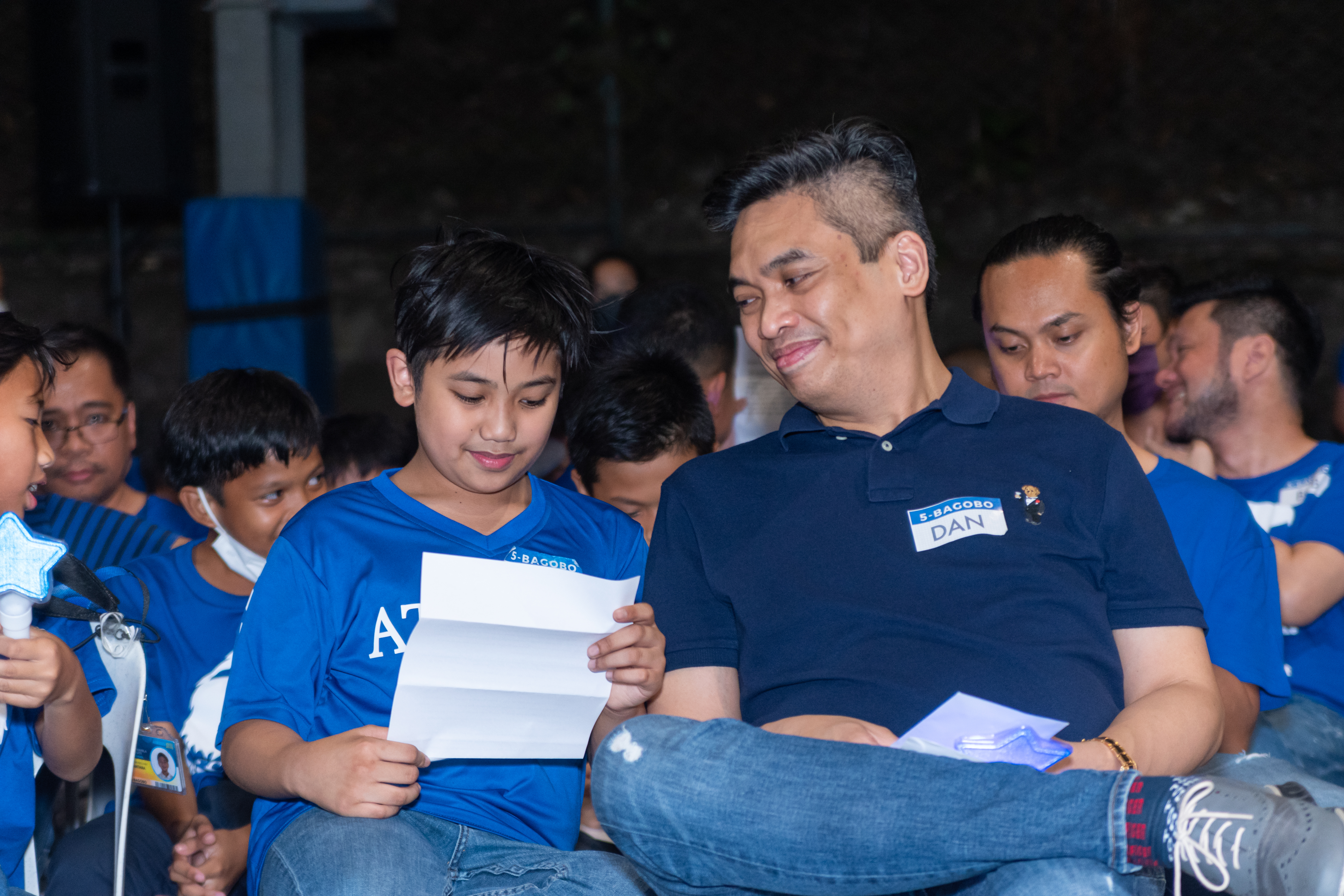 A proud dad looking on as his son takes in his father’s words of love and wisdom