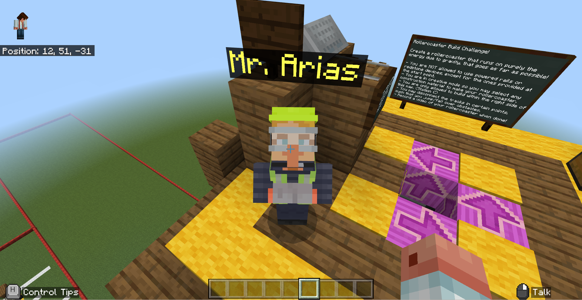 In the second station, Mr. Arias greets students and tasks them to build their own rollercoaster.