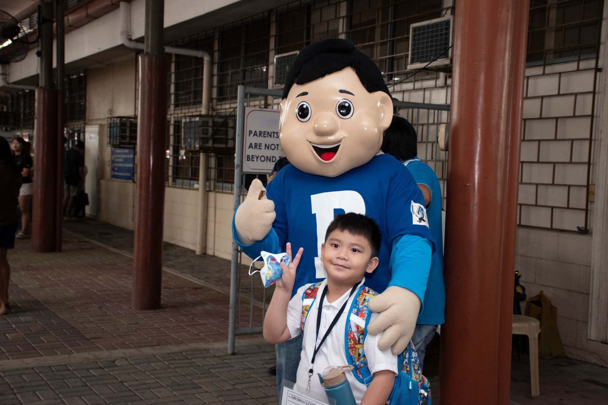 An Atenean poses with AGS Library mascot Bibo