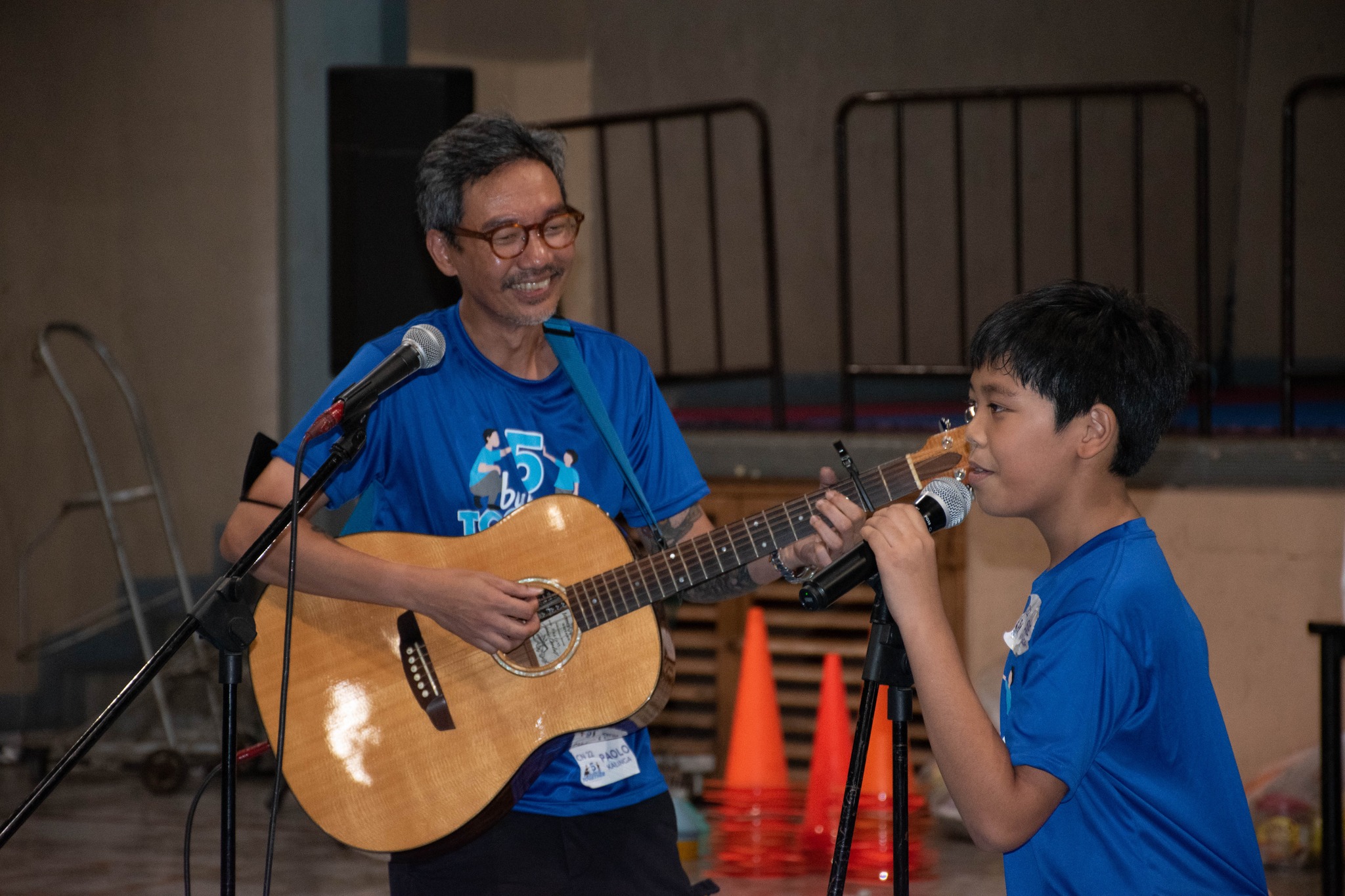 A father-son pair sings a duet
