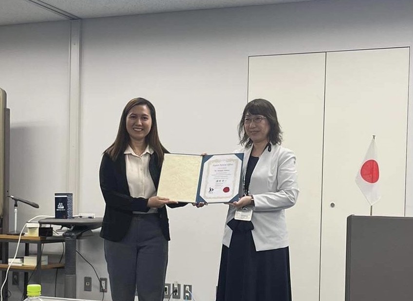 Photo: Ms Malapit receiving a certificate of completion