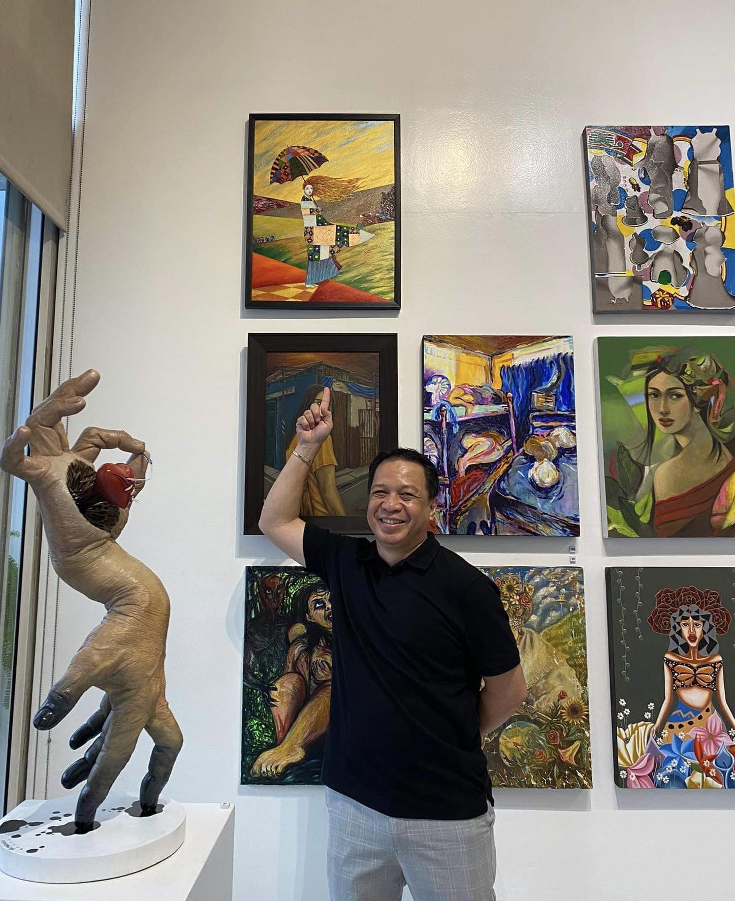 Jasper De Leon points to his creation in the "Pagtanaw" exhibit