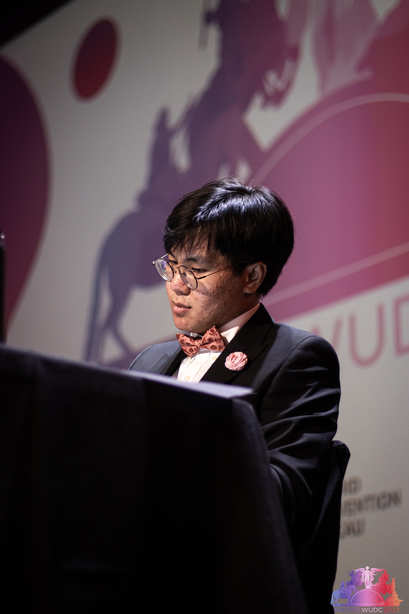Tobi speaking at the World Finals in Madrid. Photo courtesy Madrid WUDC