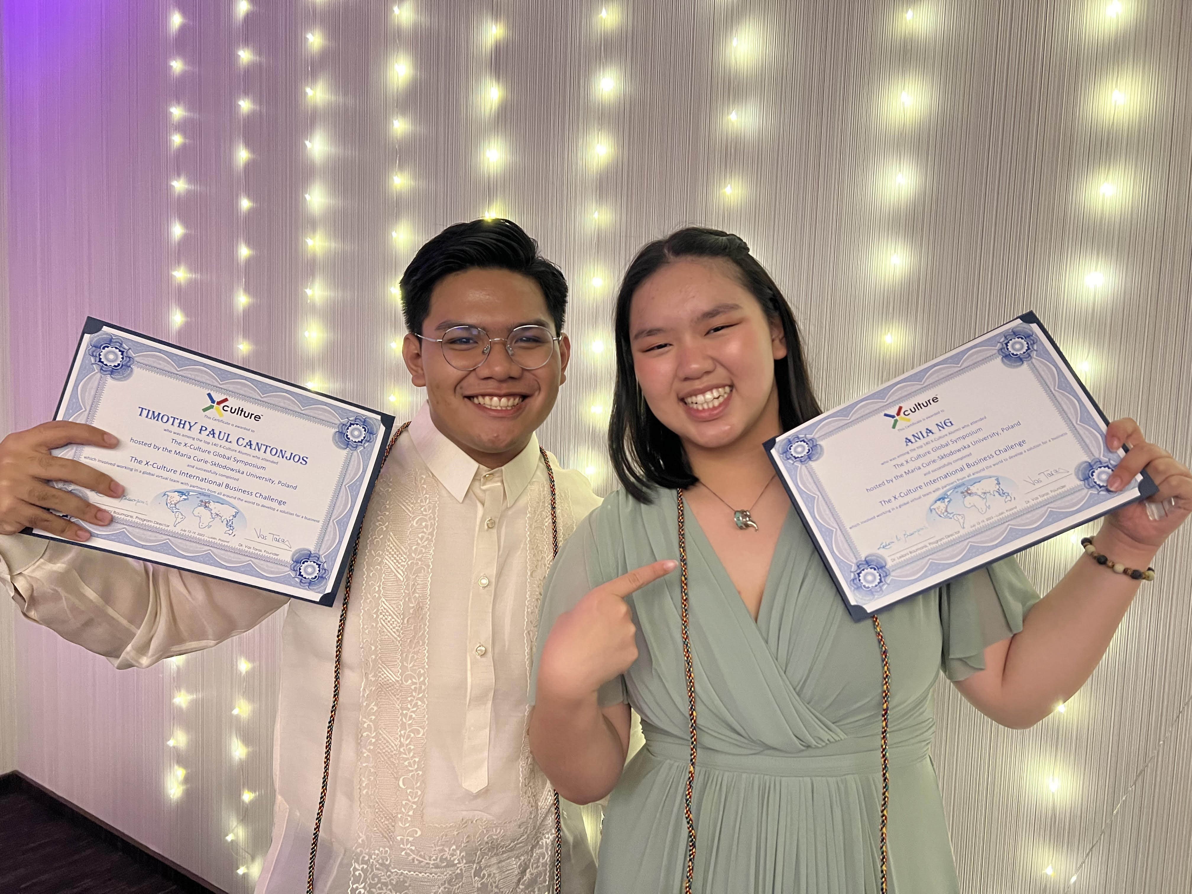 Timothy Cantonjos and Ania Ng holding their Certificate of Completion