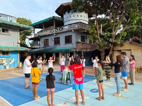 AJHS faculty and staff in prayer and 'one-ing' with Mother Earth
