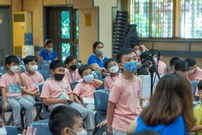 A Grade One boy asks a question during the Learning Journey session