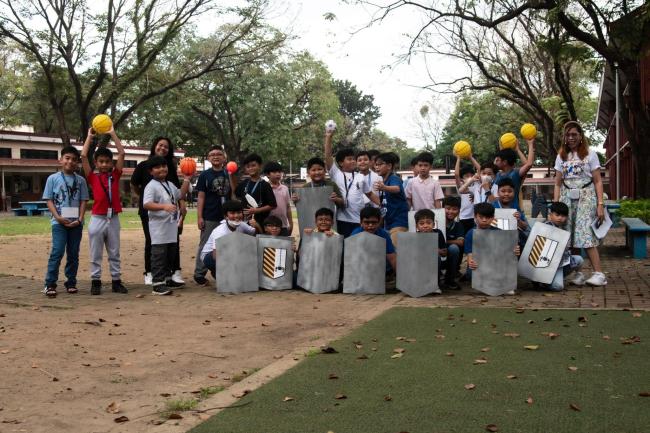 Grade 4 boys pose for a class photo following their recollection 