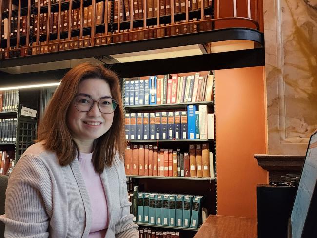 Karen Francisco in front of bookshelves