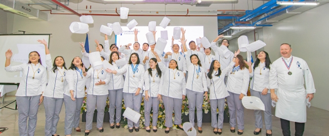 The Class of 2025 participating in the traditional toque toss