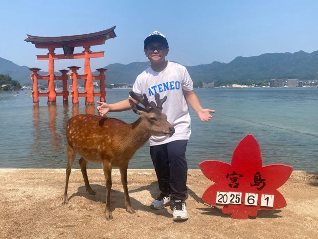 Ezekiel Alexander Mojica in front of Itsukushima Shrine's Torii Gate at Miyajima Island